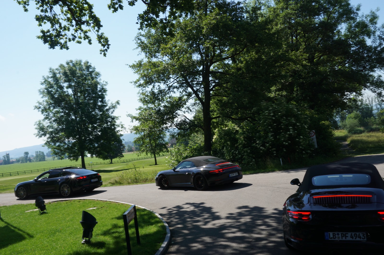 Porsche convoy on Swiss countryside road